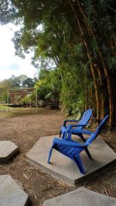 two blue chairs sitting on a concrete slab next to a goal at Dome in the Heart of Boquete. in Boquete