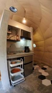 a small kitchen with a sink and a stove at Dome in the Heart of Boquete. in Boquete