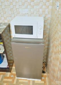 a microwave oven sitting on top of a refrigerator at CTD Global Integrated in Jos