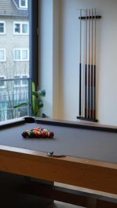 a pool table with balls on top of it at Apartment Grindelallee Hamburg in Hamburg