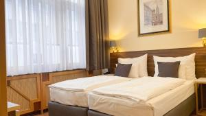 Letto o letti in una camera di Private Comfort STEPHANSPLATZ - SELF CHECK IN