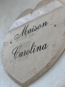 a heart shaped sign with the name of a restaurantaria at Maison Carolina in Vieste