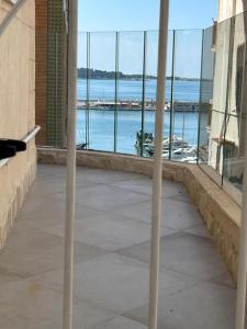 a room with a view of the ocean from a building at Maison Carolina in Vieste