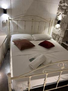 a large white bed with pillows on it at Maison Carolina in Vieste