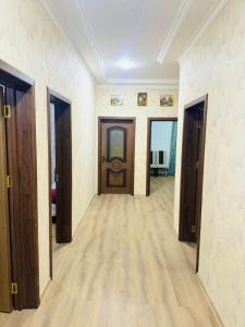 an empty hallway with wooden doors and wooden floors at Key Explore Hostel Hotel in Baku