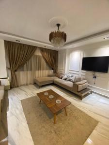 a living room with a couch and a table at مهندسين in Cairo