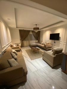 a living room with couches and a flat screen tv at مهندسين in Cairo