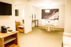 a hotel room with a table and a table and a room at Hotel Melia Lima in Lima