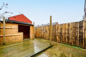 a wooden deck with a fence and a house at The Mather Place in Blackpool