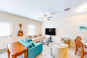 a living room with a couch and a tv at Marlin Street C in South Padre Island