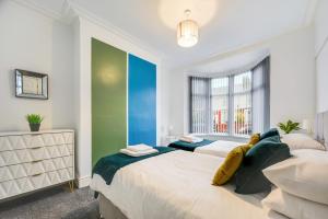 a bedroom with two beds and a large window at The Mather Place in Blackpool