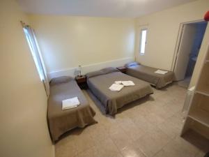 a room with two beds and a couch in it at Carlos VII in Mar del Plata