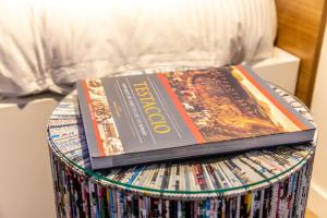 dos libros sobre un tambor de CD en Testaccio Boutique Apartment in Rome en Roma
