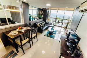 a living room with a table and a couch at Cebu City Huge Lofts by P&J in Cebu City
