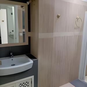 uma casa de banho com um lavatório branco e um espelho. em Castelar em Rota