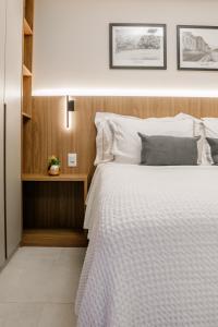 a bedroom with a bed with a white bedspread at Loft Exclusive frente Mar in Rio de Janeiro