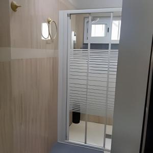 a bathroom with a window with white blinds at Castelar in Rota +14 photos