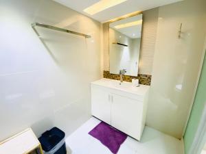 a bathroom with a sink and a mirror at Cebu City Huge Lofts by P&J in Cebu City +214 photos