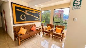 a living room with a couch and two chairs at La Mansion Casa Hotel in Andahuaylas