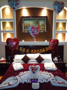 a bed with heart balloons on top of it at Paradise Boutique Hotel in Cairo