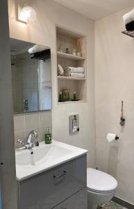 a white bathroom with a sink and a toilet at LA PETITE MAISON DE MAUSSANE *** in Maussane-les-Alpilles
