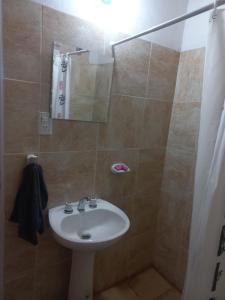 a bathroom with a white sink and a shower at Vista a la montaña in Chilecito