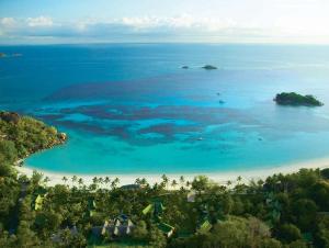 an aerial view of a beach and the ocean at Paradise Sun Hotel Seychelles in Baie Sainte Anne