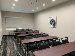 a conference room with tables and chairs and a whiteboard at Best Western Houston Bush IAH Intercontinental Airport Inn in Humble