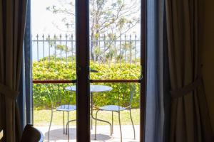 a window with a view of a table and chairs at Best Western Hotel Santa Caterina in Acireale