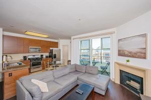 a living room with a couch and a fireplace at Marina Apartment Pool,Gym,Jacuzzi in Los Angeles