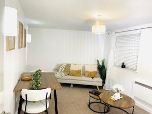 a living room with a table and a couch at Cozy Apartment in Birchwood in Risley