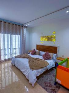 a bedroom with a large bed and a chandelier at Luxury of Mesnana in Tangier