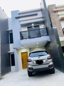 a car parked in front of a building at Cozy 2 storey fully furnished house. in Davao City