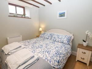a small bedroom with a bed and a window at Mordon Moor Cottage in Stockton-on-Tees