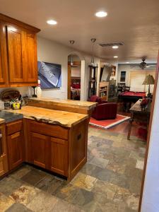 a kitchen with wooden cabinets and a living room at Lake Tahoe Luxury Guest Quarters in South Lake Tahoe