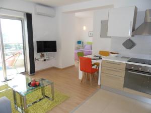 a kitchen and living room with a table and chairs at Eden Beach Apartment 611 in Limassol