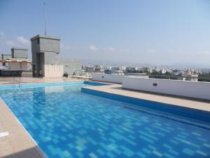 a swimming pool on the roof of a building at Eden Beach Apartment 611 in Limassol