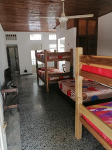 a room with four bunk beds and a ceiling at Casa de relajación low cost in La Dorada