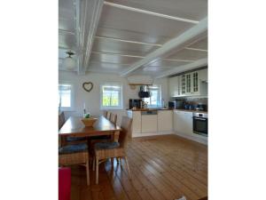 a kitchen with white cabinets and a wooden table at Vincent family holiday home in Niederdorf +17 photos