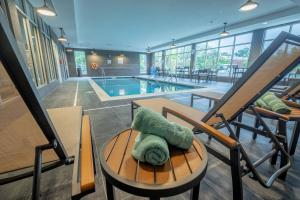 a room with a pool and a table with a pillow at Courtyard by Marriott Toledo West in Toledo