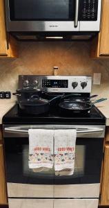 a stove top oven with two towels on it at Lost Bluff Casa in San Antonio
