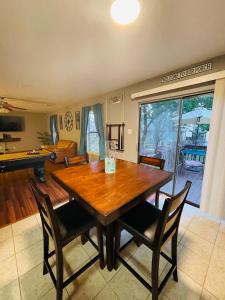 a dining room with a wooden table and chairs at Lost Bluff Casa in San Antonio