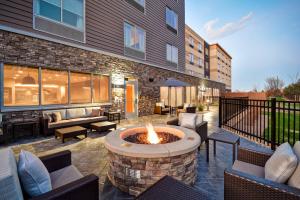 a patio with a fire pit in front of a building at Fairfield Inn & Suites by Marriott Plymouth in Plymouth