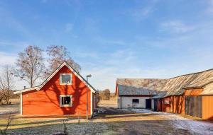 an orange barn sits next to a building at Nice Home In Falkenberg With Wi-fi in Falkenberg