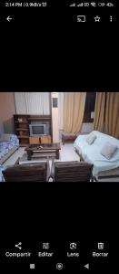 een foto van een kamer met twee bedden en een televisie bij Alojamiento Punta Negra in Punta Negra