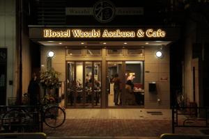 a building with a sign that reads hospital wasatch australiasias and cafe at Hostel Wasabi Asakusa in Tokyo