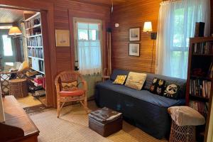 a living room with a blue couch and a chair at Beach Retreat in Harbor Springs