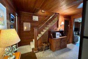 a room with a staircase with a desk and a lamp at Beach Retreat in Harbor Springs