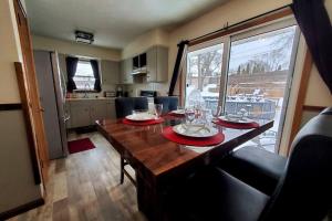 a dining room table with plates and wine glasses on it at Maple. Pleasant 4 bedroom house with pool in Omaha