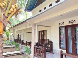 a row of benches on the side of a house at Bias Bungalows in Gili Islands